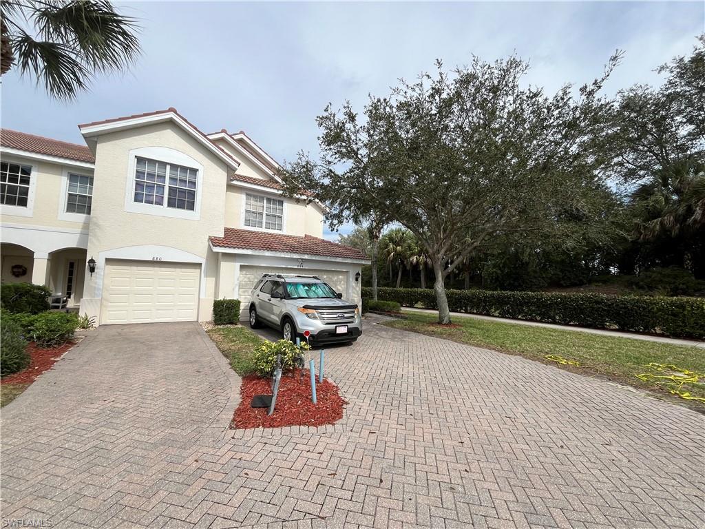 884 Hampton Circle, Unit 159 Naples, FL 34105 - Photo 1 of 28 a view of a house with backyard and sitting area