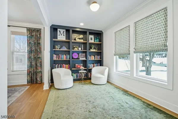 a living room with furniture and a book shelf