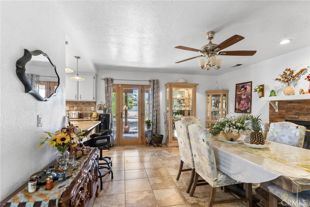 20071 Serrano Road Apple Valley, CA 92307 - Photo 13 of 38 a dining room with furniture and a chandelier