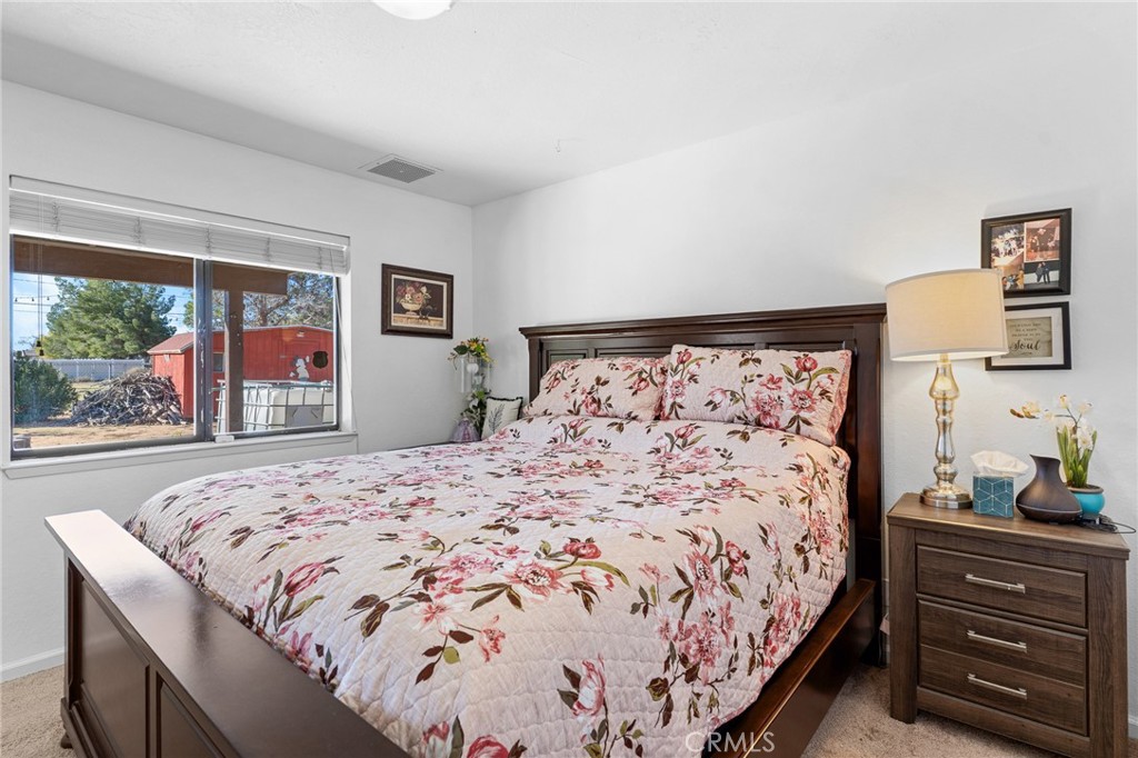 20071 Serrano Road Apple Valley, CA 92307 - Photo 22 of 38 a bedroom with a bed and a dresser next to a window