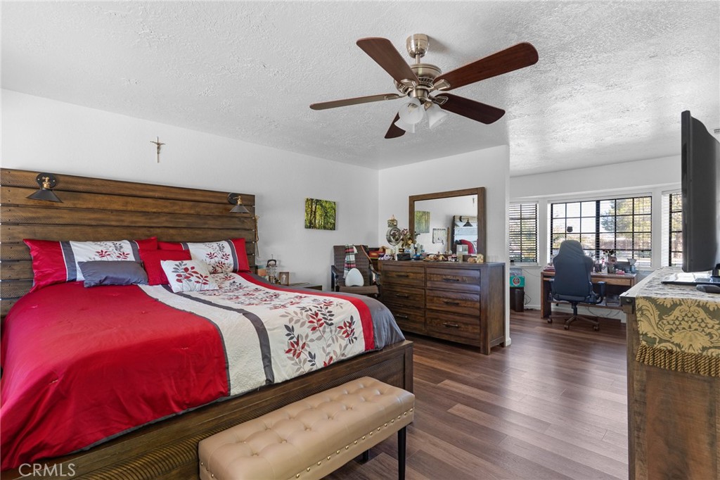 20071 Serrano Road Apple Valley, CA 92307 - Photo 25 of 38 a bedroom with a bed and wooden floor