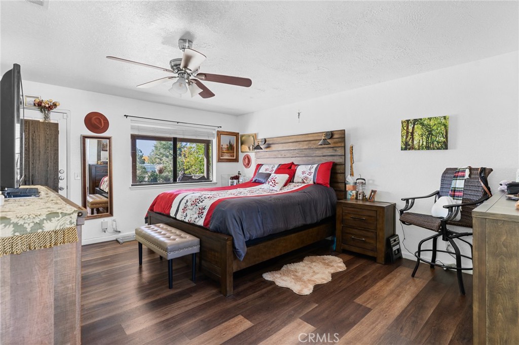 20071 Serrano Road Apple Valley, CA 92307 - Photo 26 of 38 a bedroom with a bed and a chandelier