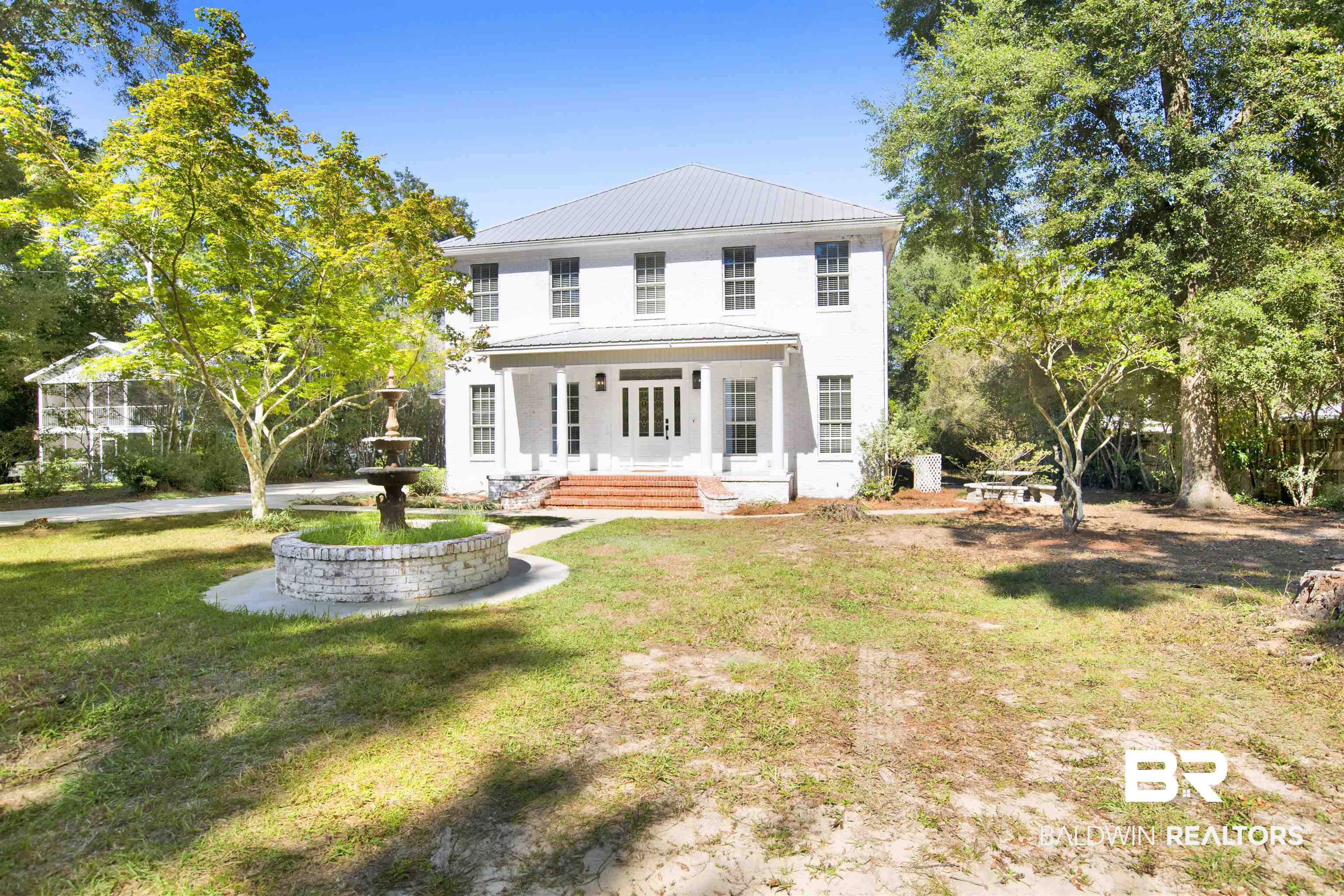 11835 Island Drive Foley, AL 36535 - Photo 2 of 53 View of front of house with a metal roof, a front lawn, french doors, and a patio