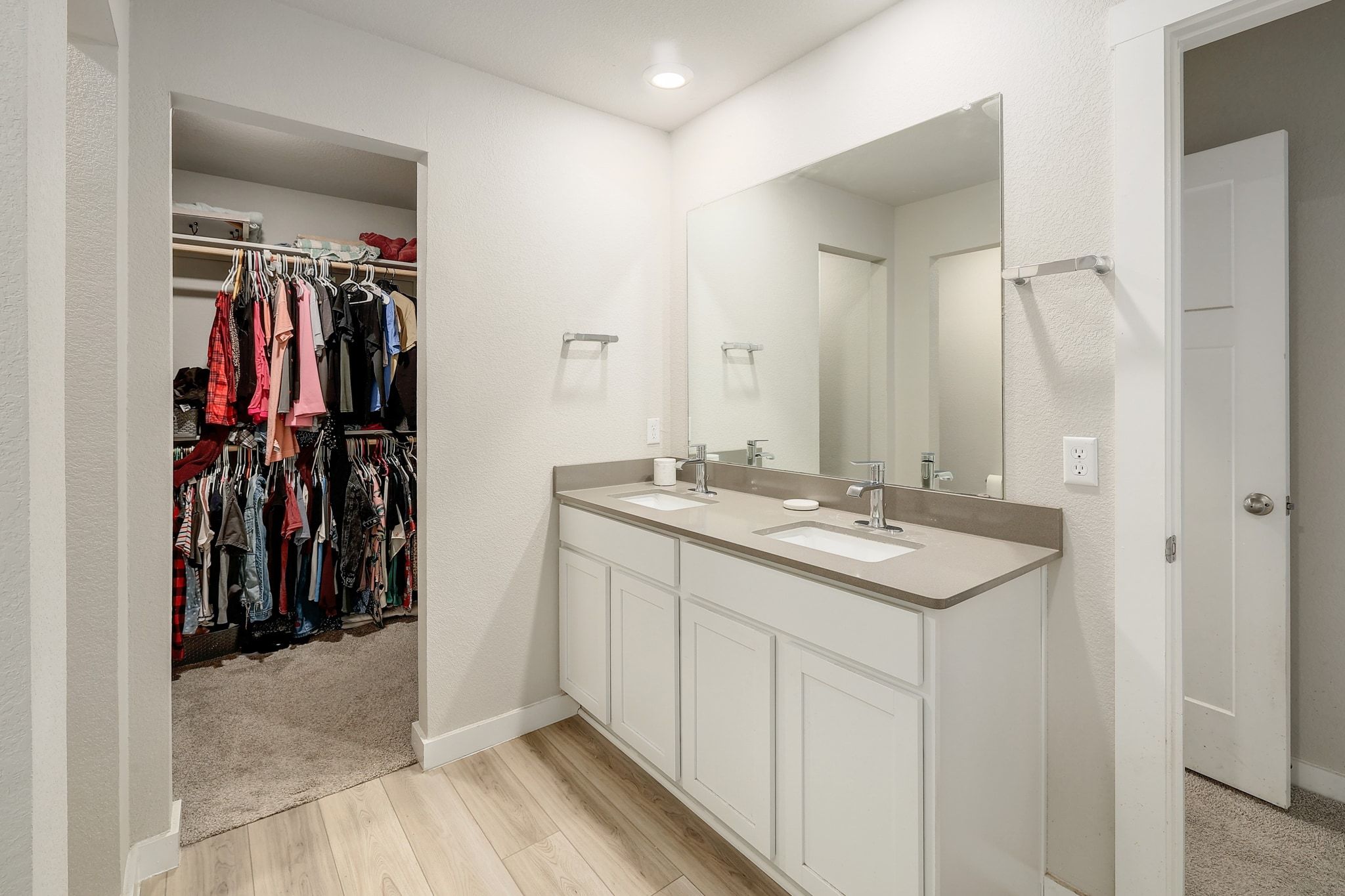 204 Halford Road Georgetown, TX 78633 - Photo 15 of 27 Bathroom featuring a spacious closet, double vanity, and light wood-style floors