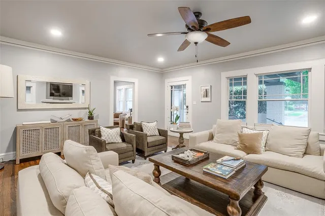 a living room with furniture ceiling fan and a window