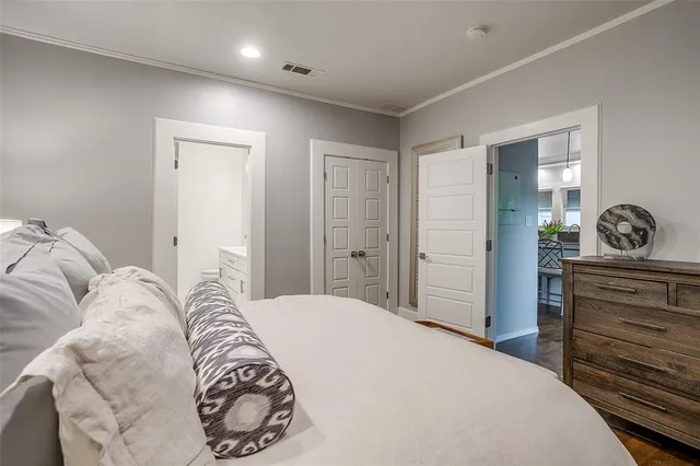 a bedroom with a bed and a dresser