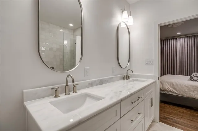 a bathroom with a double vanity sink and a mirror