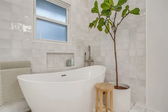 a white bath tub sitting in a bathroom