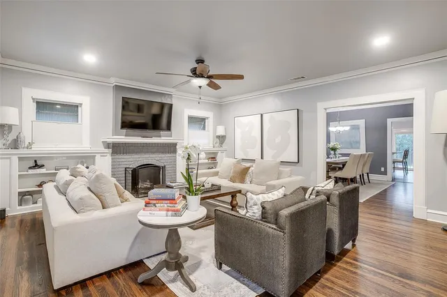 a living room with furniture a fireplace and a flat screen tv