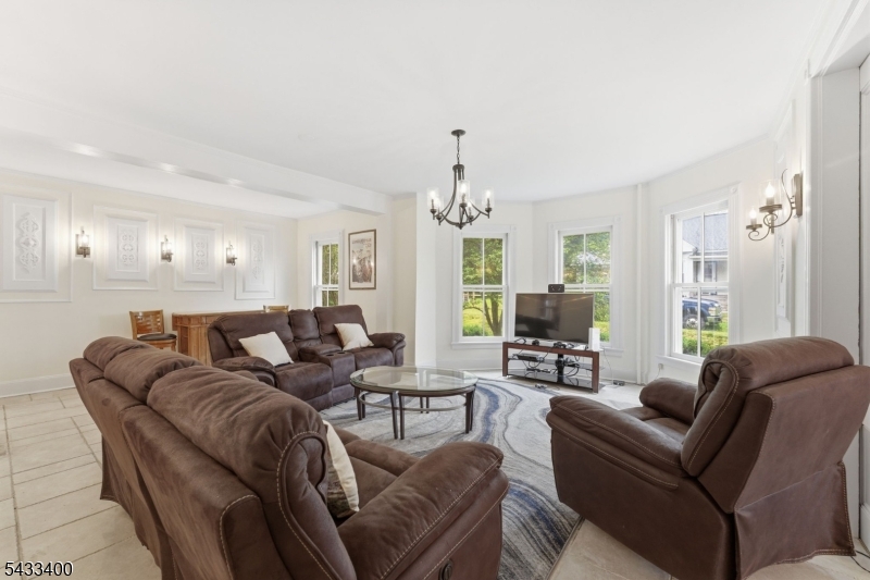 61 New Street Hampton, NJ 08827 - Photo 17 of 45 a living room with furniture a large window and a chandelier