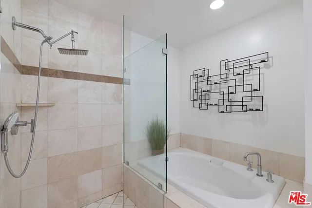a bathroom with a bathtub and a shower