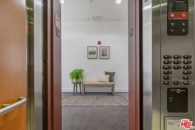 a view of a hallway and a livingroom with furniture