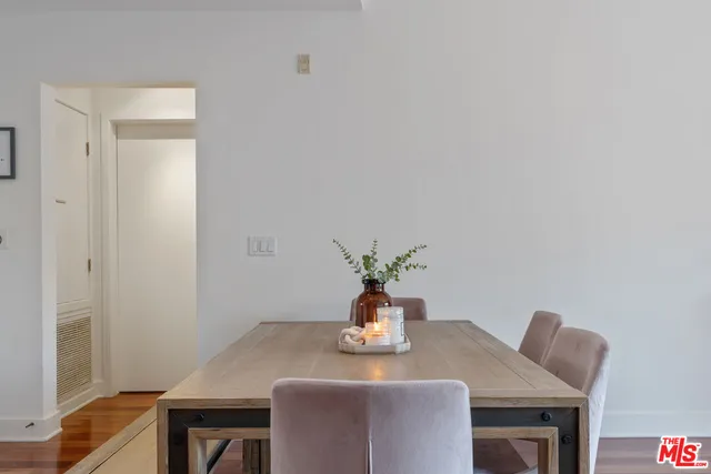 a dining room with table chairs and wooden floor