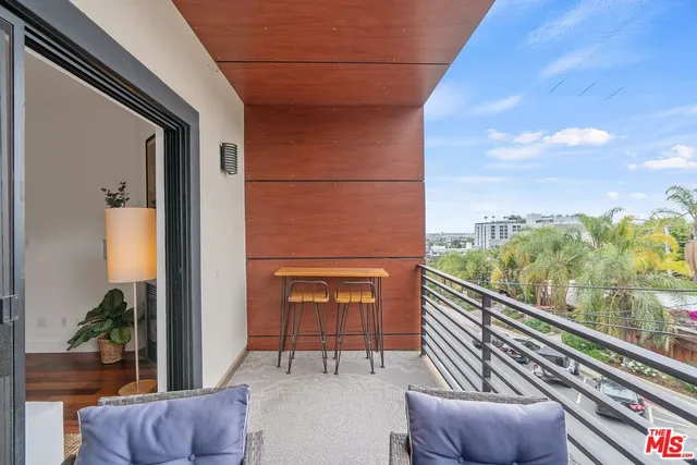 a balcony with furniture and a potted plant