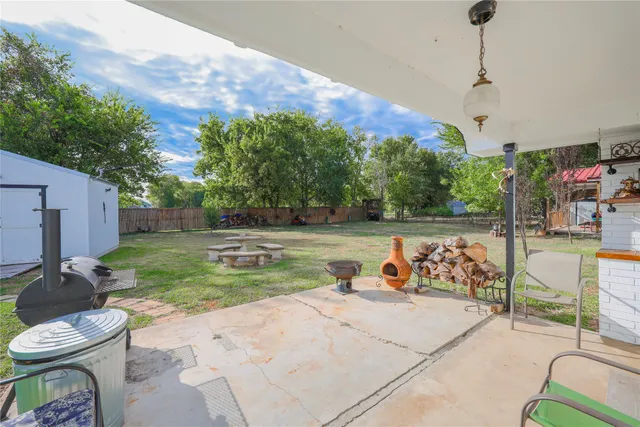 a view of a patio with couches table and chairs and potted plants
