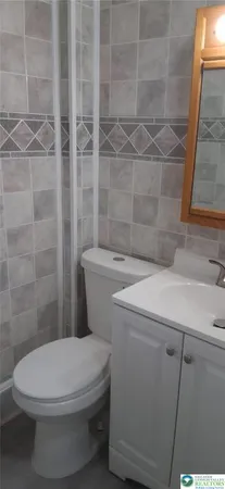 a white toilet sitting next to a bathroom sink