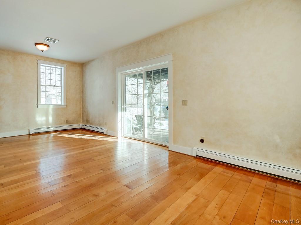 6 Bart Bull Road Middletown, NY 10941 - Photo 9 of 24 Empty room featuring a baseboard heating unit and light wood-style flooring