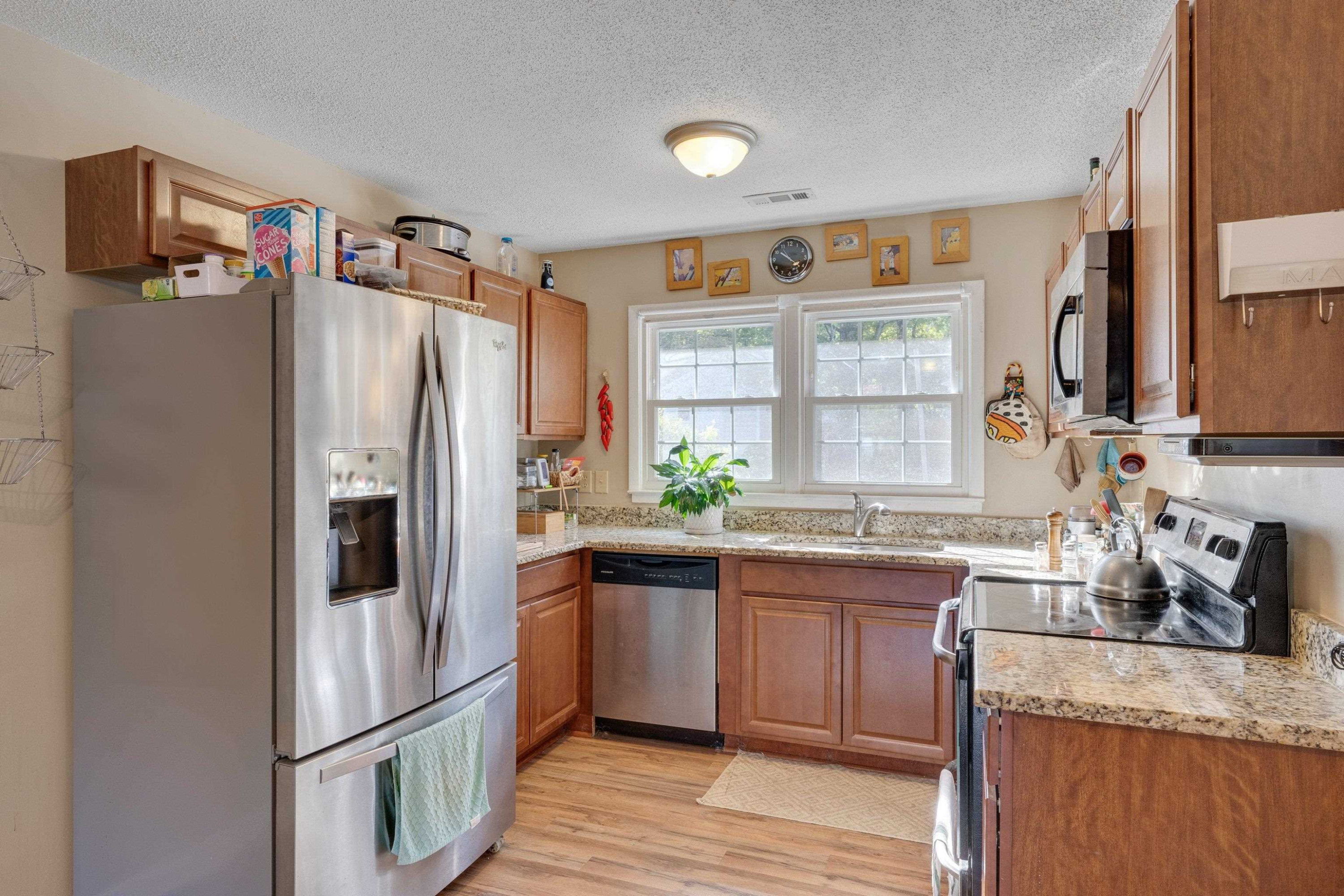704 Wheat Mill Road Durham, NC 27704 - Photo 11 of 23 a kitchen with granite countertop a refrigerator and a sink