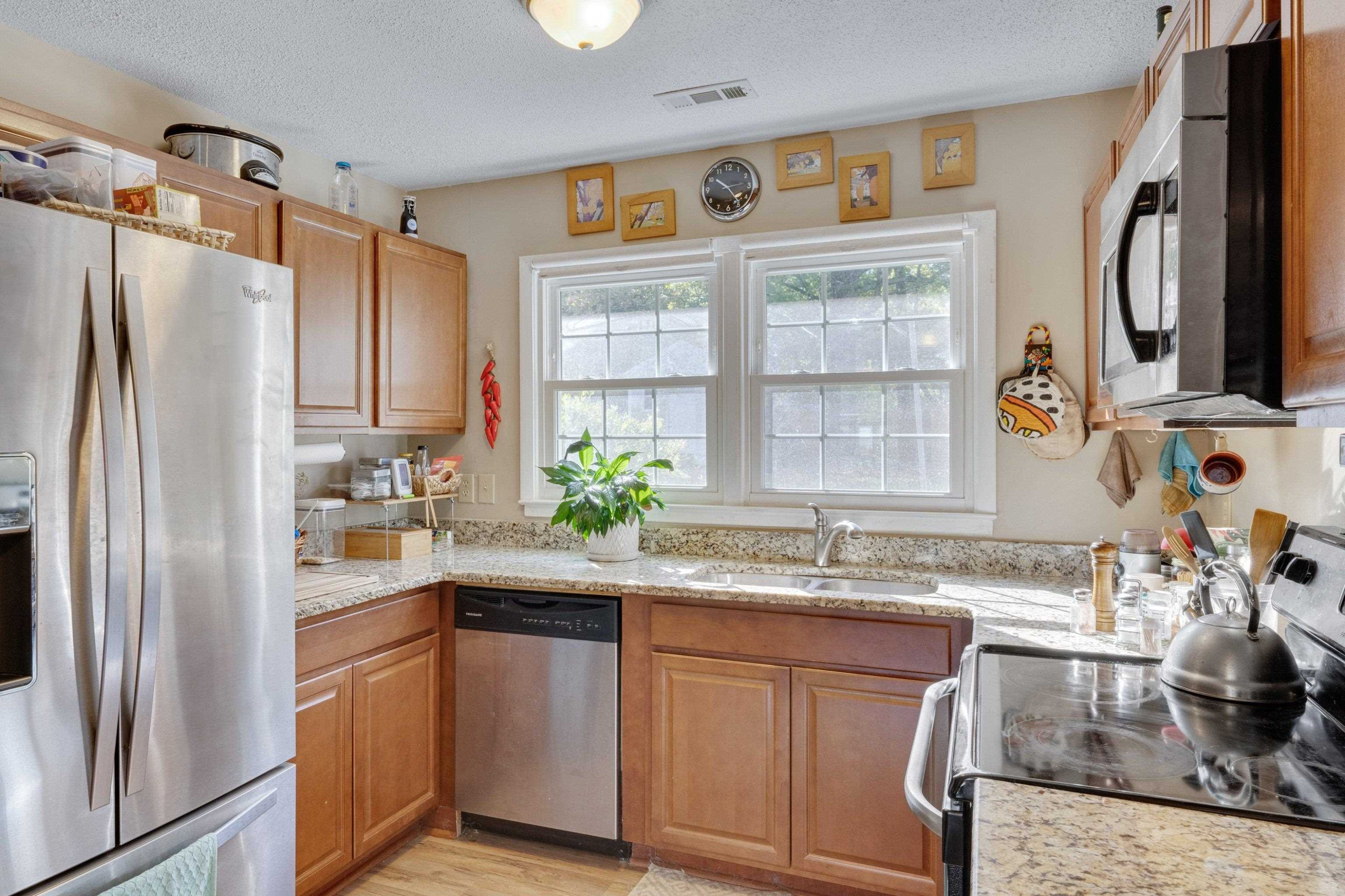 704 Wheat Mill Road Durham, NC 27704 - Photo 12 of 23 a kitchen with granite countertop a sink stainless steel appliances and cabinets