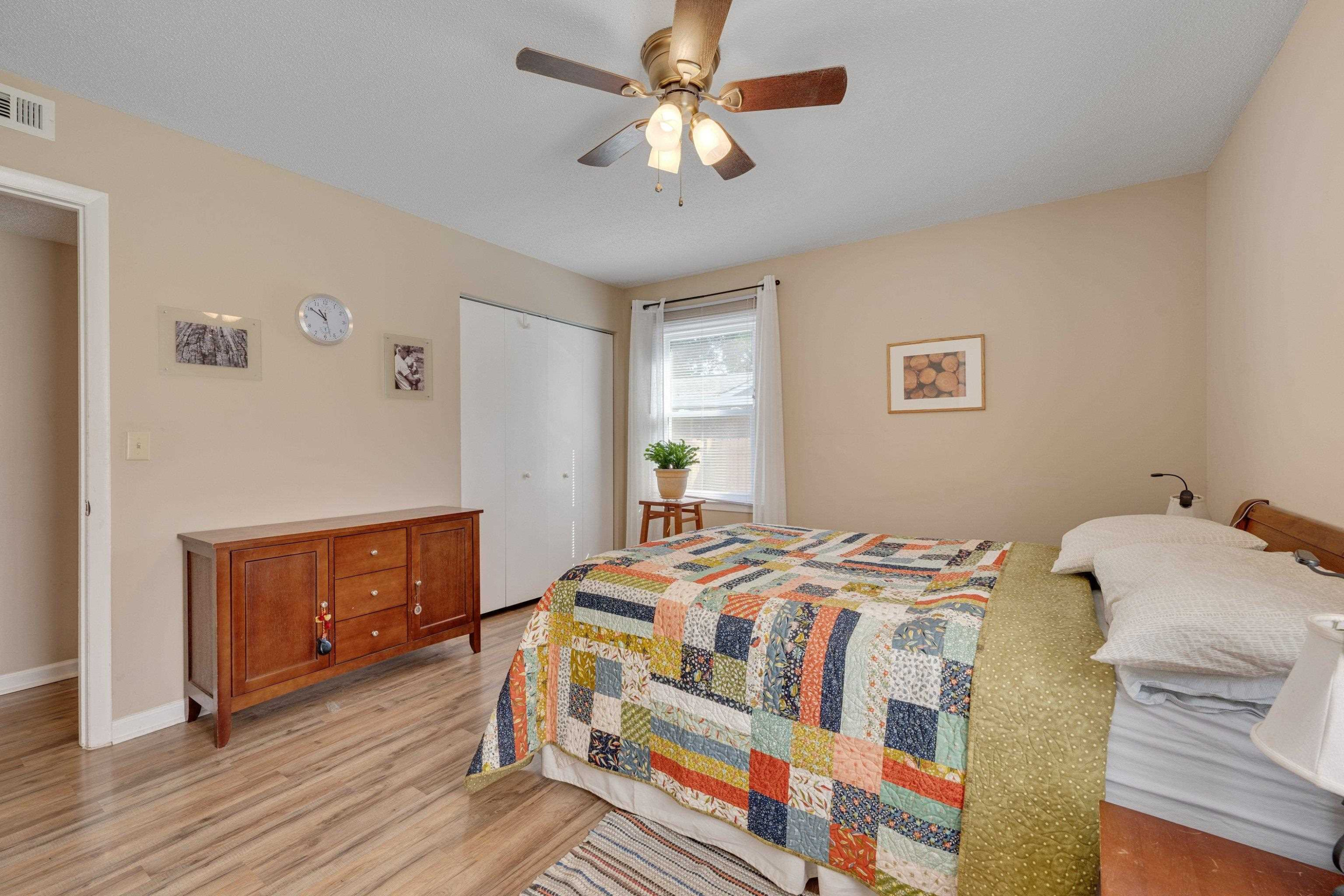 704 Wheat Mill Road Durham, NC 27704 - Photo 17 of 23 a bedroom with a bed and a chandelier