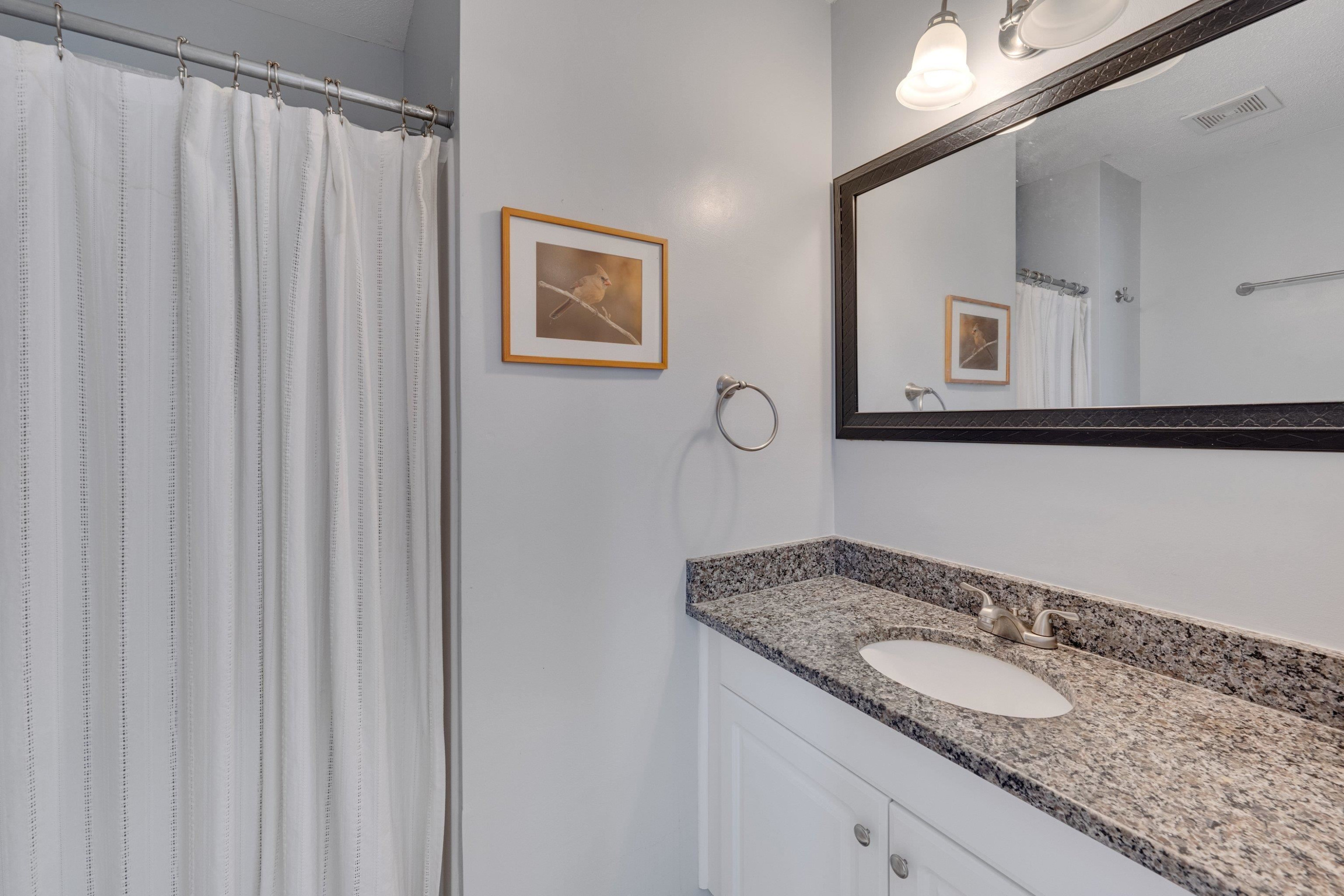 704 Wheat Mill Road Durham, NC 27704 - Photo 19 of 23 a bathroom with a granite countertop sink and a mirror