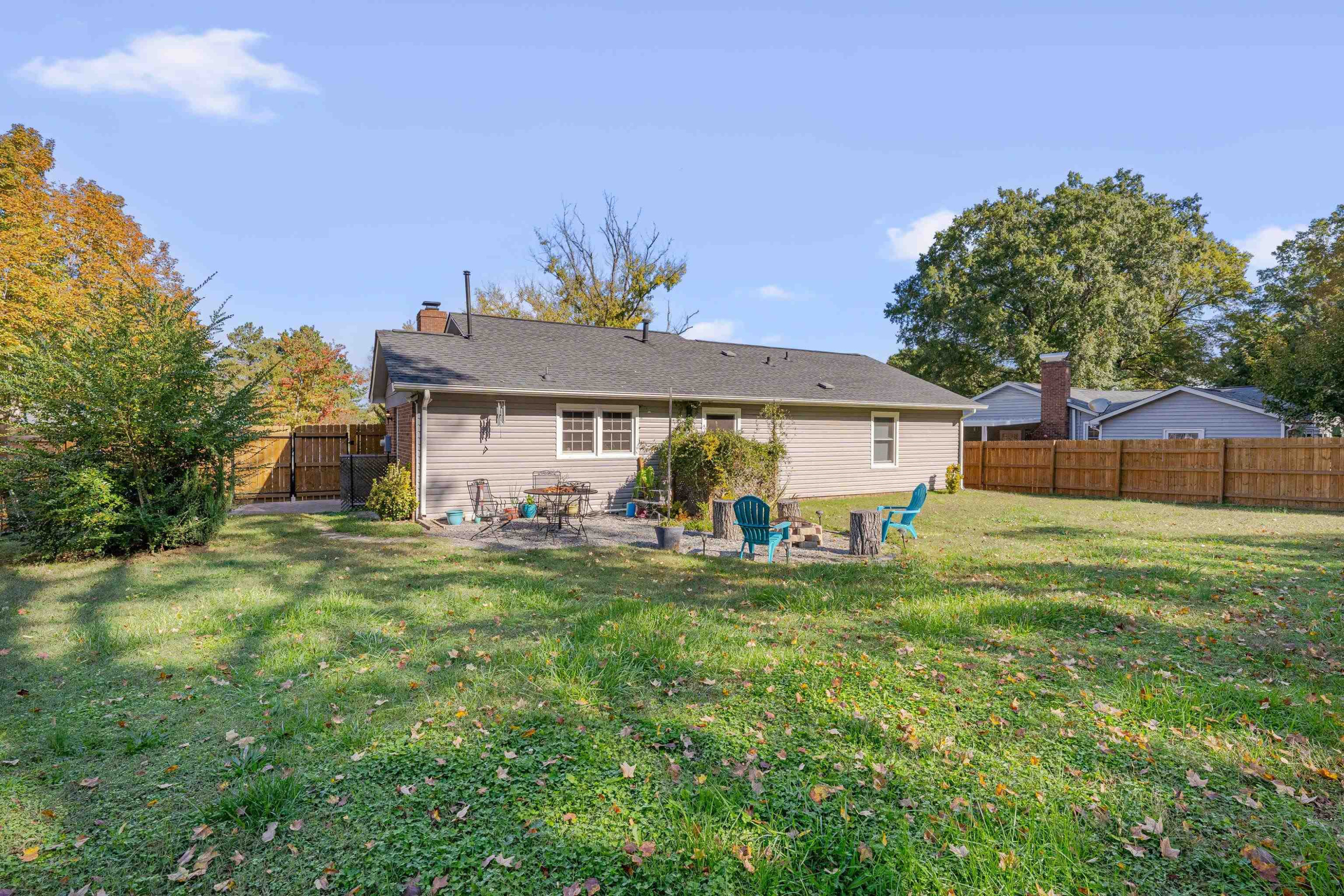 704 Wheat Mill Road Durham, NC 27704 - Photo 21 of 23 a front view of a house with a garden and trees