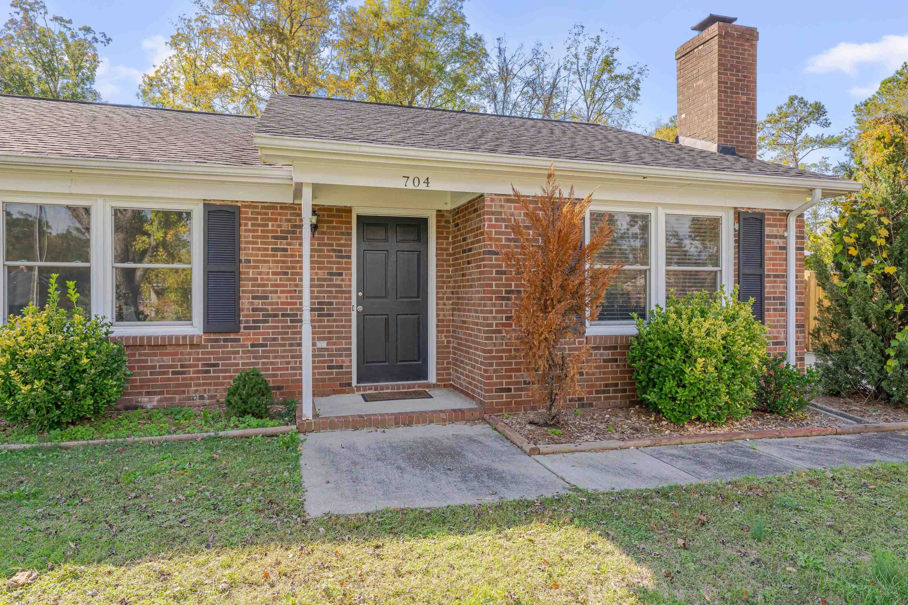 704 Wheat Mill Road Durham, NC 27704 - Photo 3 of 23 a front view of a house with garden