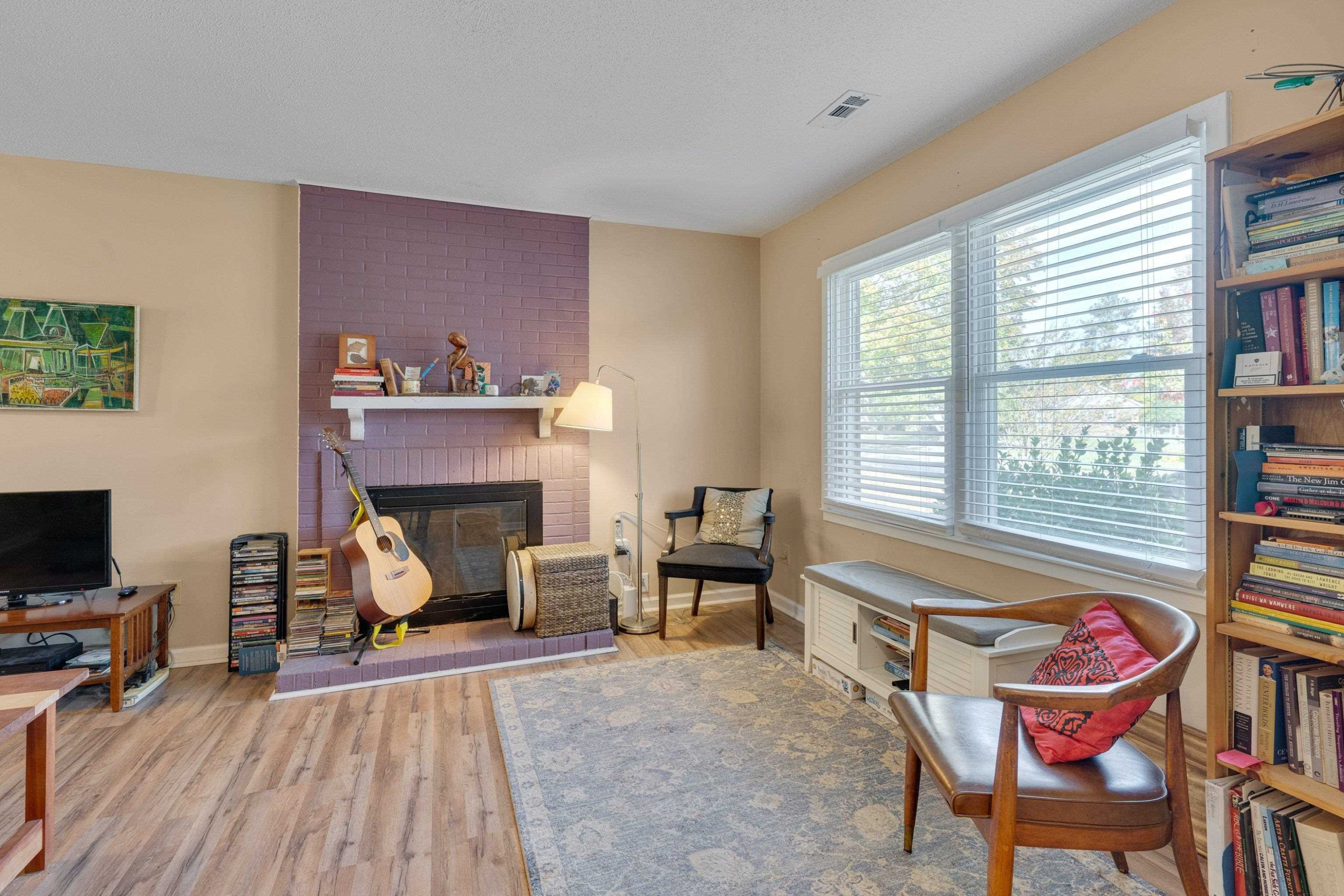 704 Wheat Mill Road Durham, NC 27704 - Photo 5 of 23 a living room with furniture and a fireplace