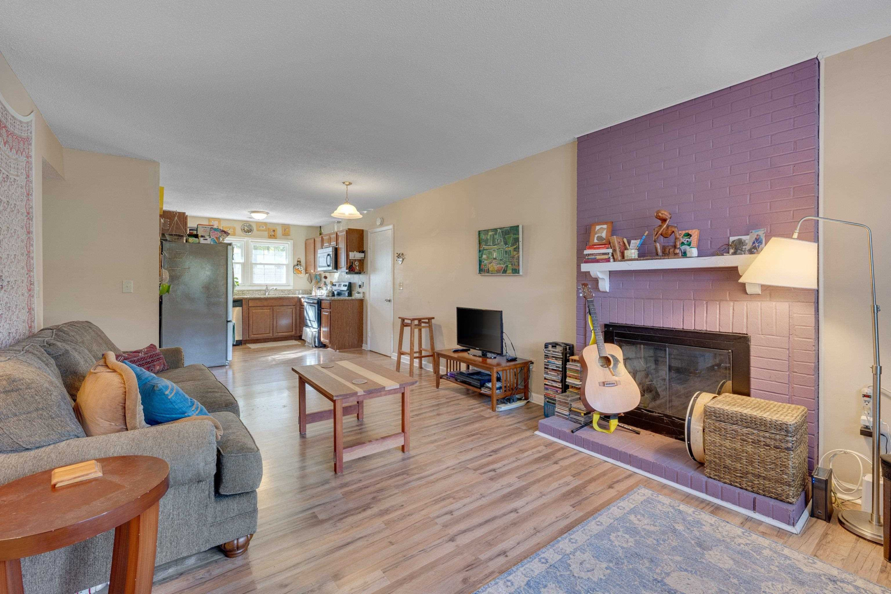 704 Wheat Mill Road Durham, NC 27704 - Photo 6 of 23 a living room with furniture and a fireplace