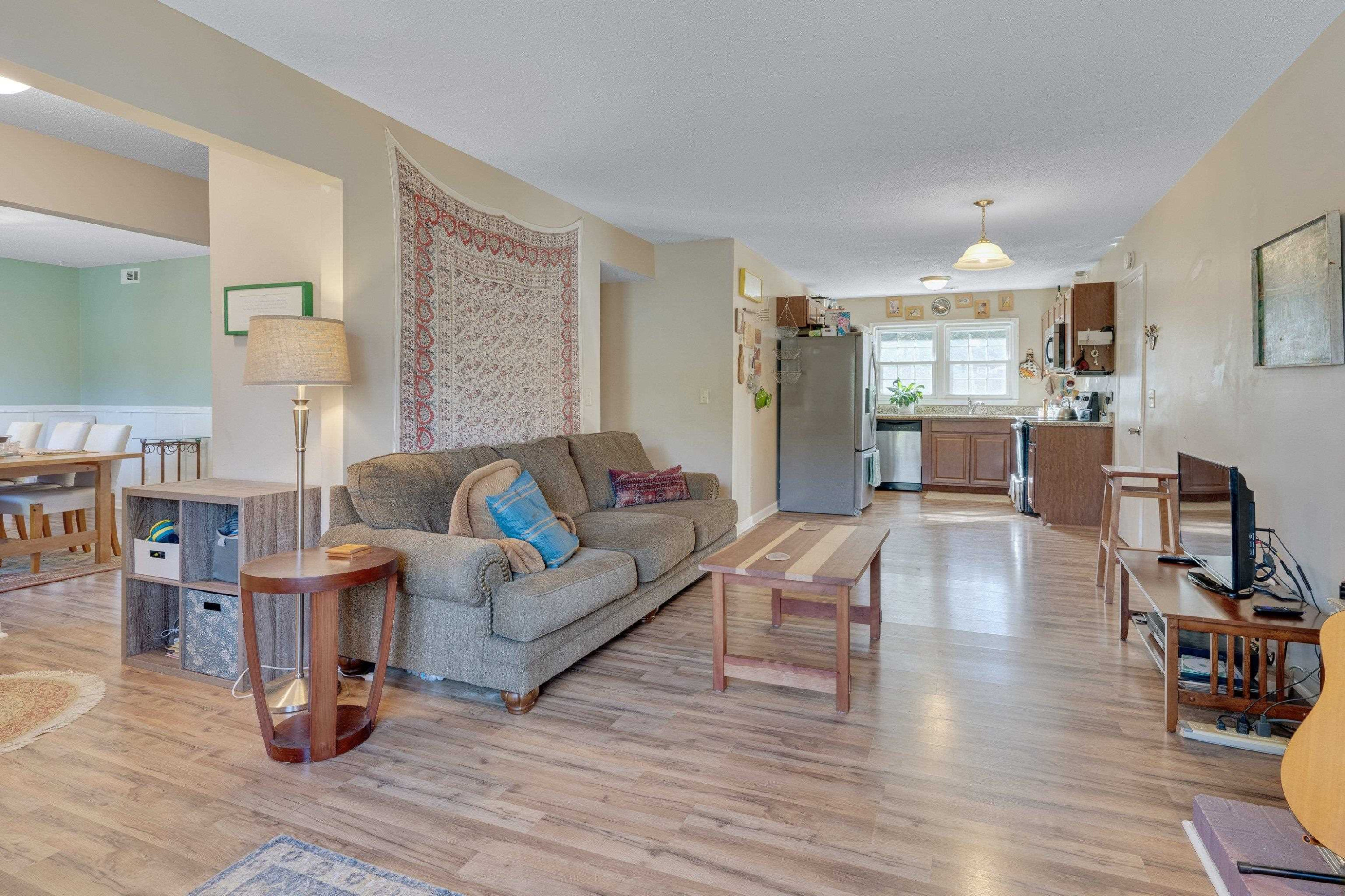 704 Wheat Mill Road Durham, NC 27704 - Photo 7 of 23 a living room with furniture and a wooden floor