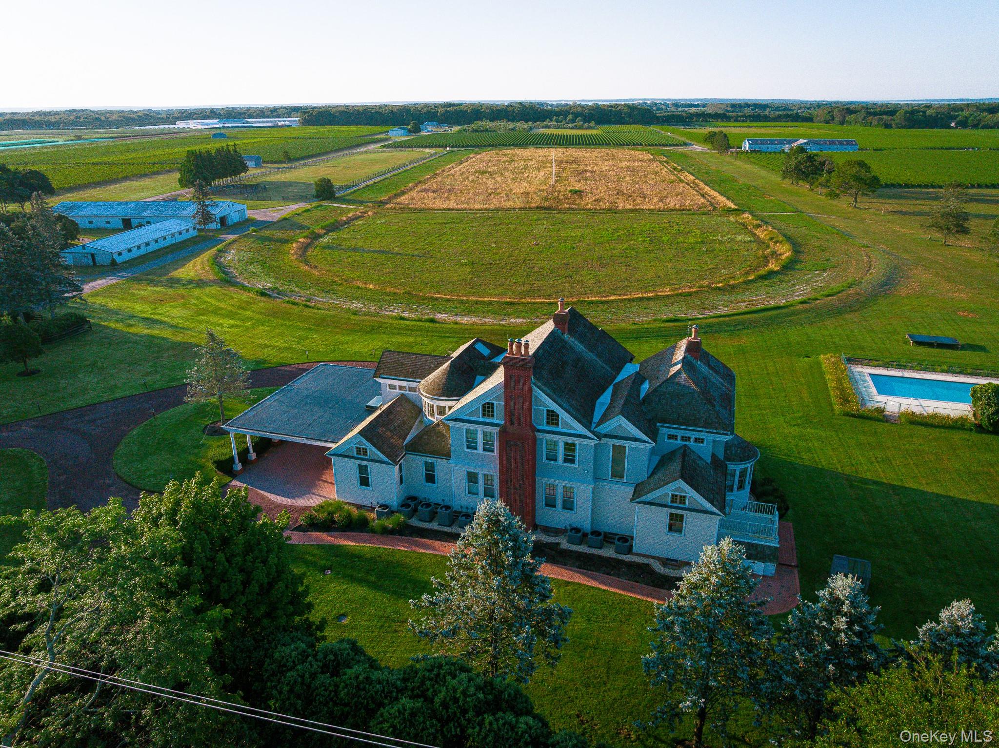 6133 Sound Avenue Riverhead, NY 11901 - Photo 1 of 42 an aerial view of a house with a garden and lake view