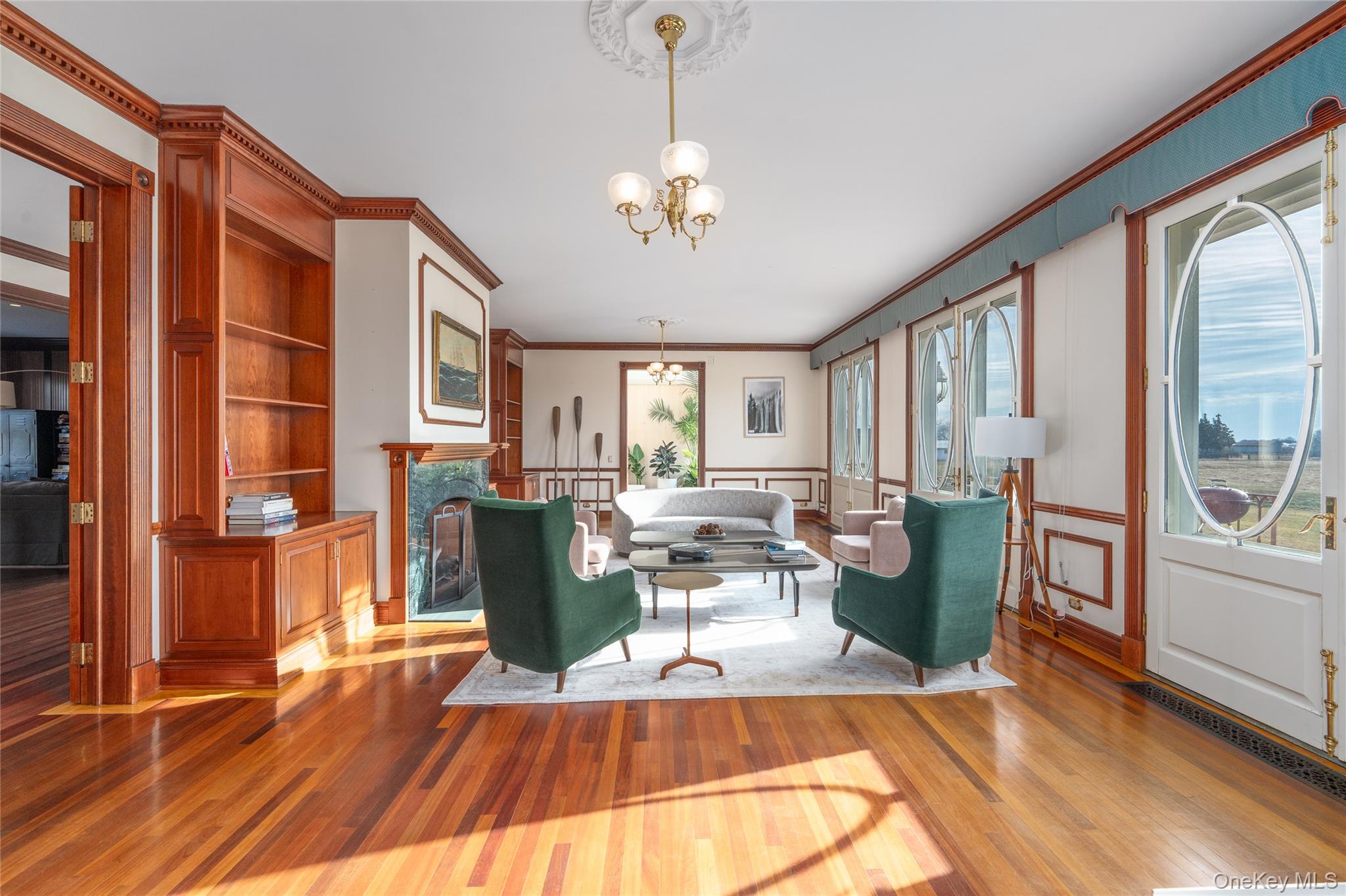 6133 Sound Avenue Riverhead, NY 11901 - Photo 13 of 42 a living room with fireplace furniture and a wooden floor