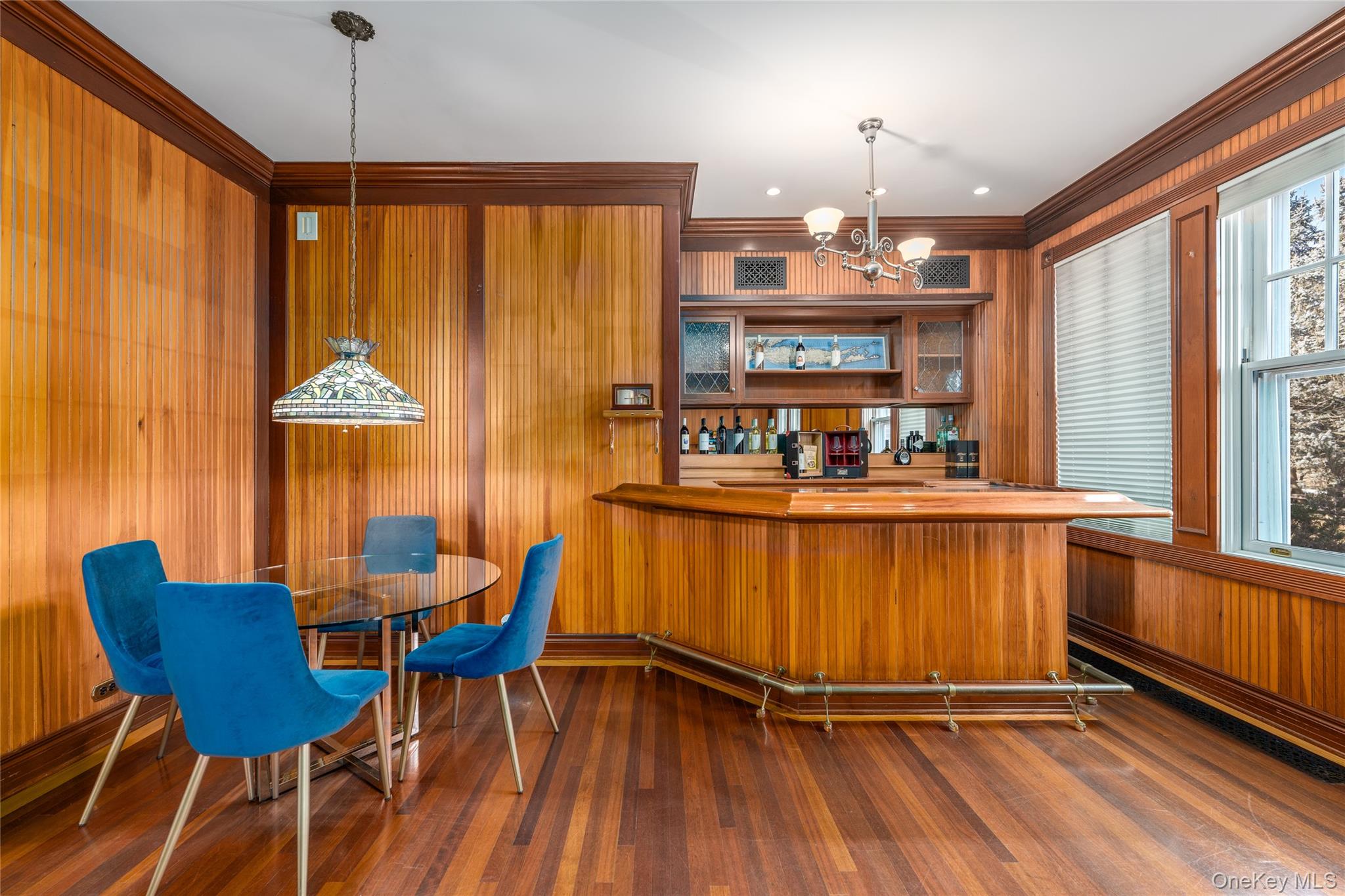 6133 Sound Avenue Riverhead, NY 11901 - Photo 15 of 42 a kitchen with stainless steel appliances granite countertop a table chairs and a chandelier