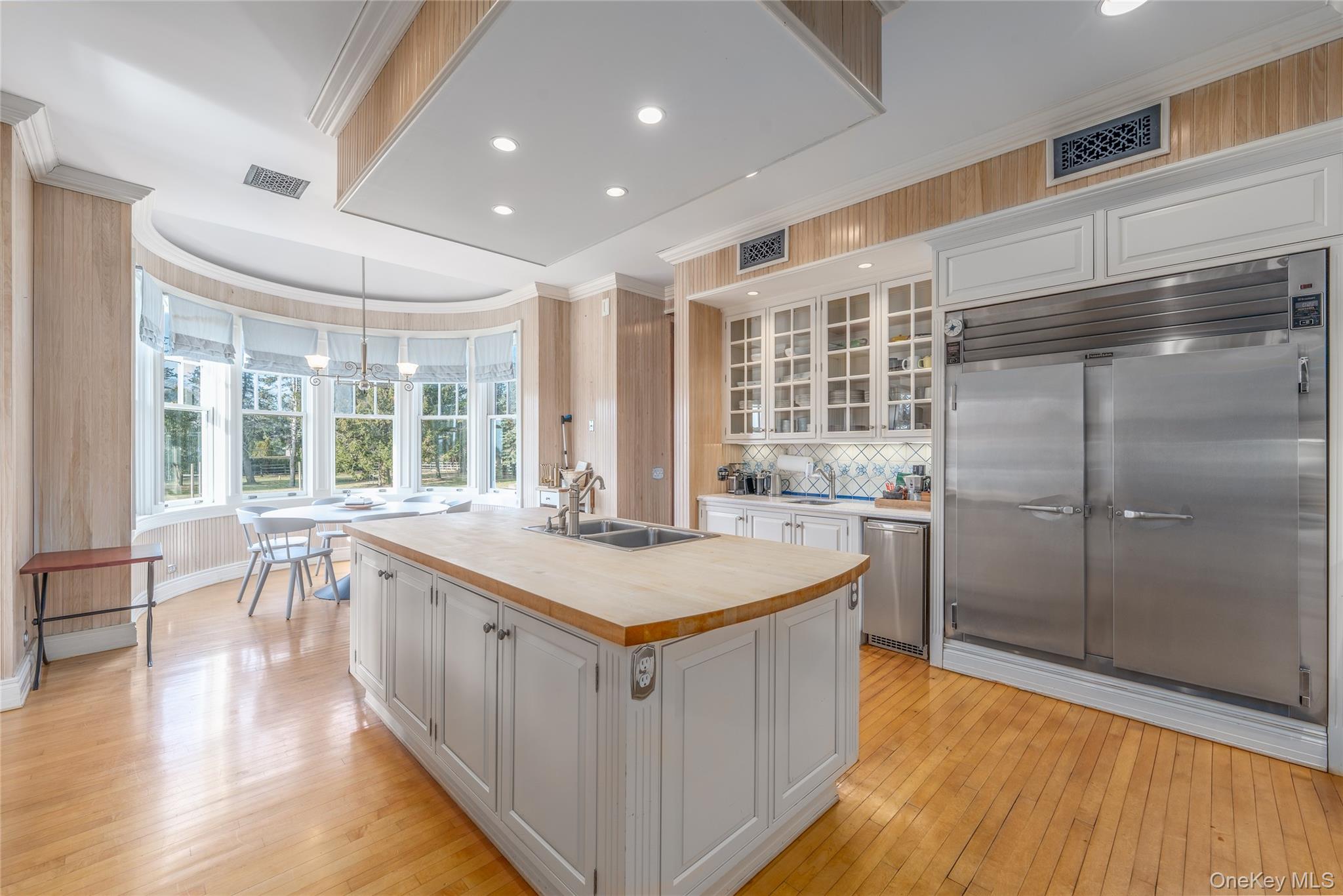 6133 Sound Avenue Riverhead, NY 11901 - Photo 19 of 42 a large white kitchen with a large window