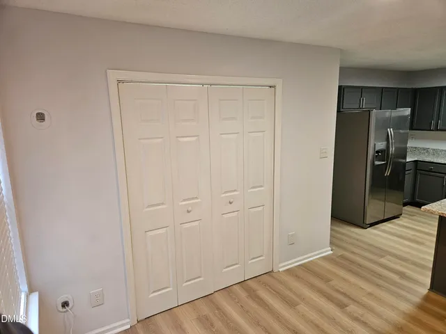 a view of empty room with wooden floor
