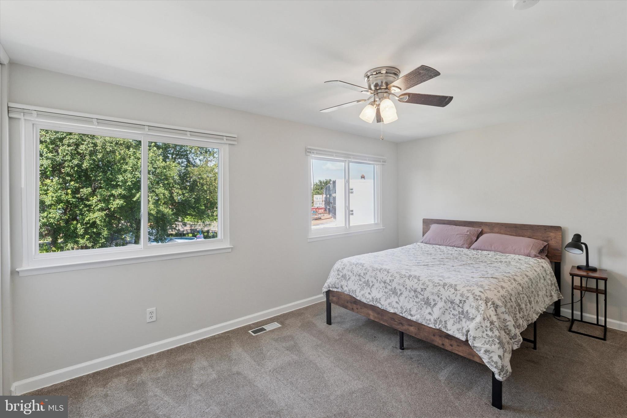12218 Aster Road Philadelphia, PA 19154 - Photo 14 of 25 a bedroom with a bed and a chandelier