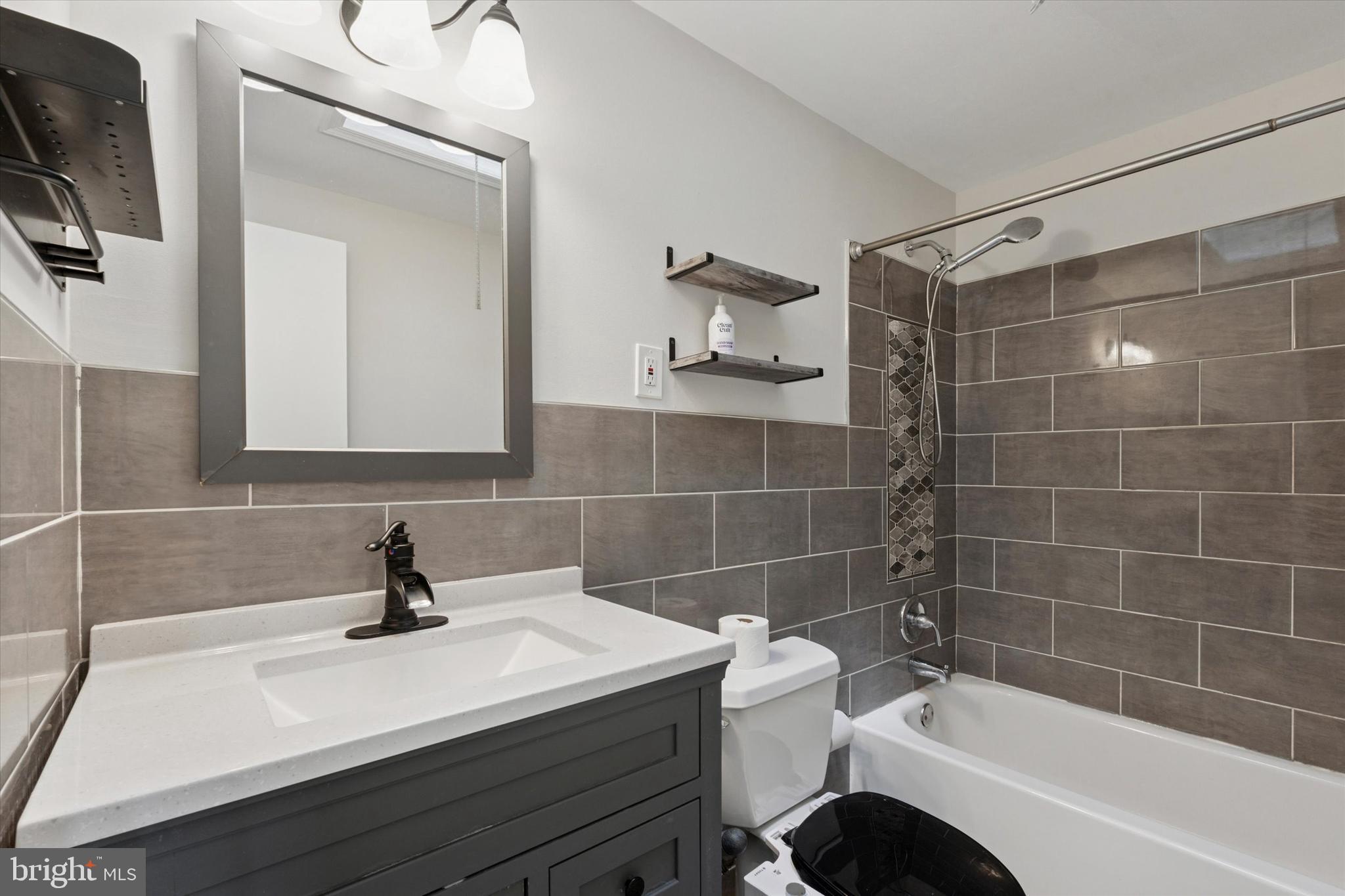 12218 Aster Road Philadelphia, PA 19154 - Photo 15 of 25 a bathroom with a sink a toilet a mirror and shower