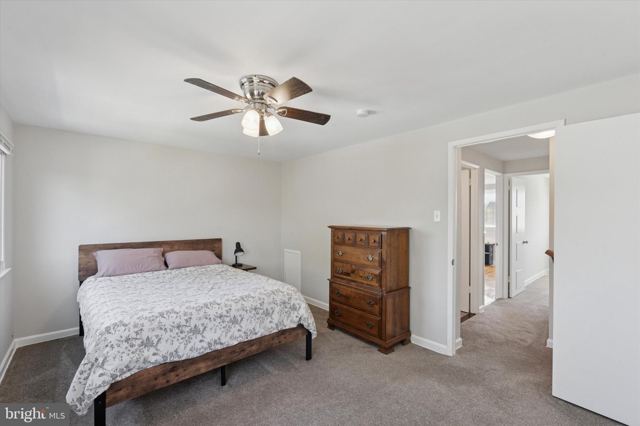 12218 Aster Road Philadelphia, PA 19154 - Photo 16 of 25 a bedroom with a bed and a chandelier