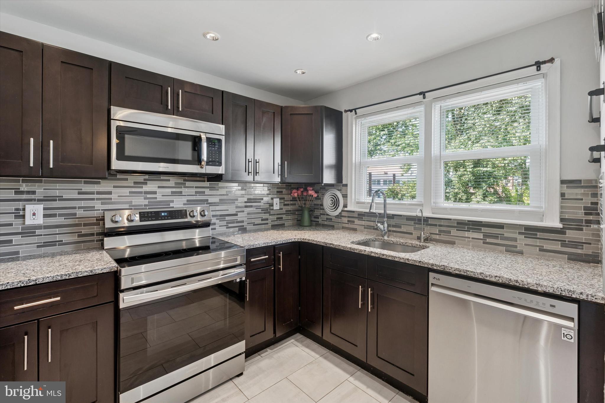 12218 Aster Road Philadelphia, PA 19154 - Photo 2 of 25 a kitchen with stainless steel appliances granite countertop cabinets sink and window