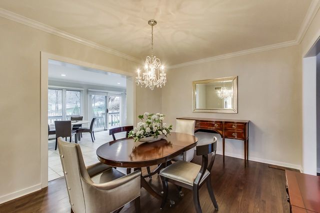 1317 Lyons Street Evanston, IL 60201 - Photo 11 of 46 a dining room with furniture a chandelier and wooden floor