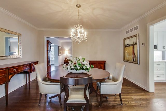 1317 Lyons Street Evanston, IL 60201 - Photo 12 of 46 a dining room with furniture a chandelier and wooden floor