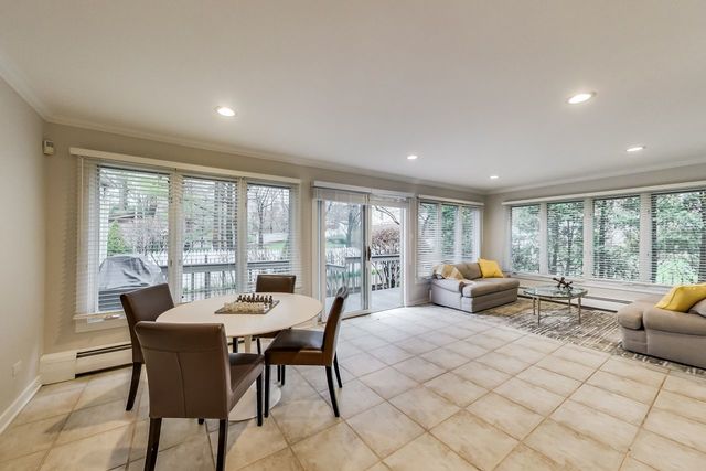 1317 Lyons Street Evanston, IL 60201 - Photo 16 of 46 a dining room with furniture a large window and a table