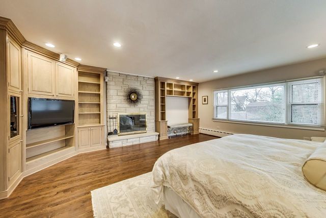 1317 Lyons Street Evanston, IL 60201 - Photo 25 of 46 a spacious bedroom with a large bed and a flat screen tv
