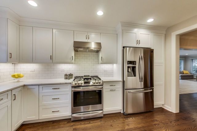 1317 Lyons Street Evanston, IL 60201 - Photo 8 of 46 a kitchen with stainless steel appliances a stove a refrigerator and cabinets