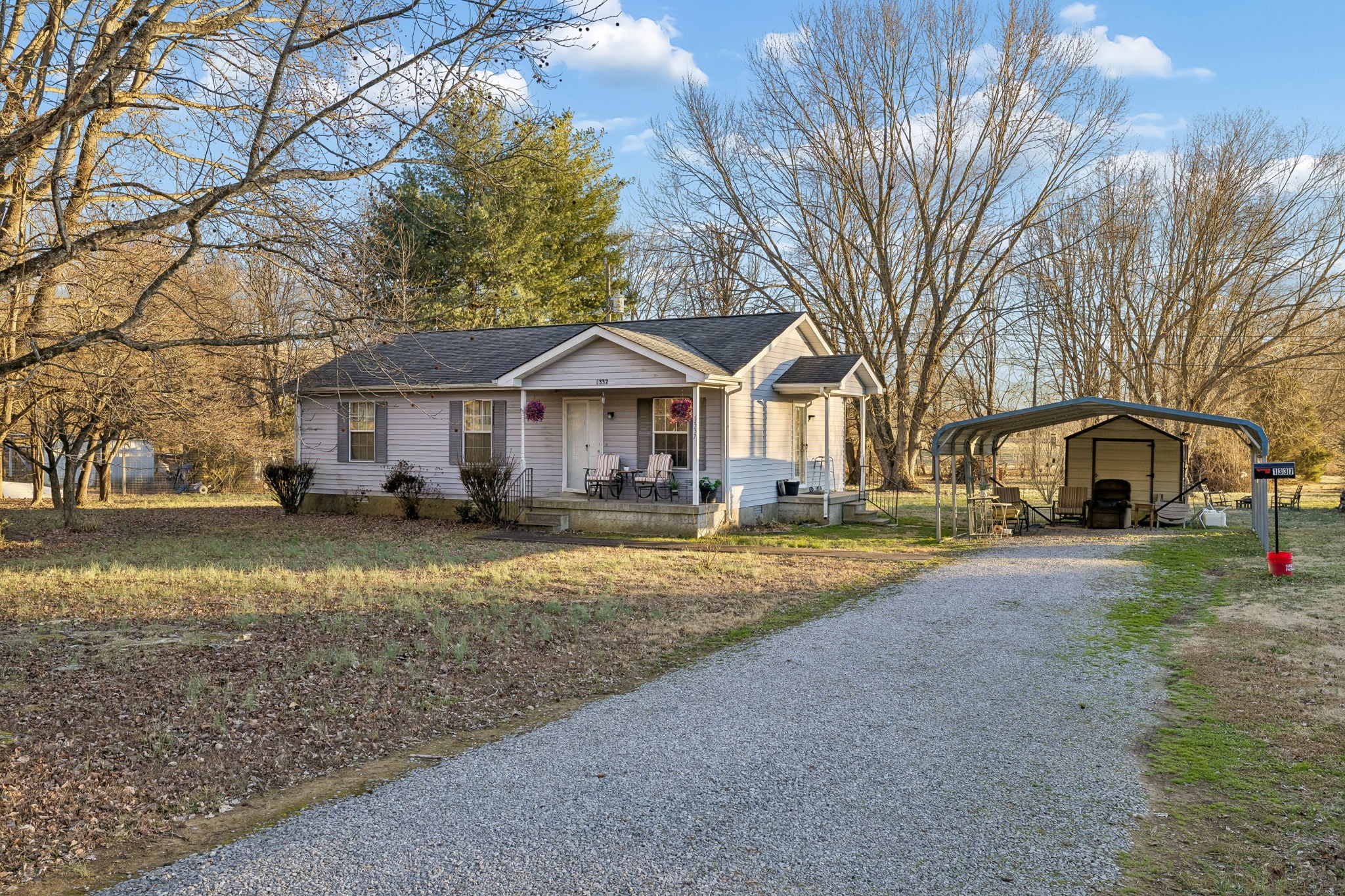 1337 Oaklawn Road Chapmansboro, TN 37035 - Photo 33 of 37 a front view of a house with a yard and trees