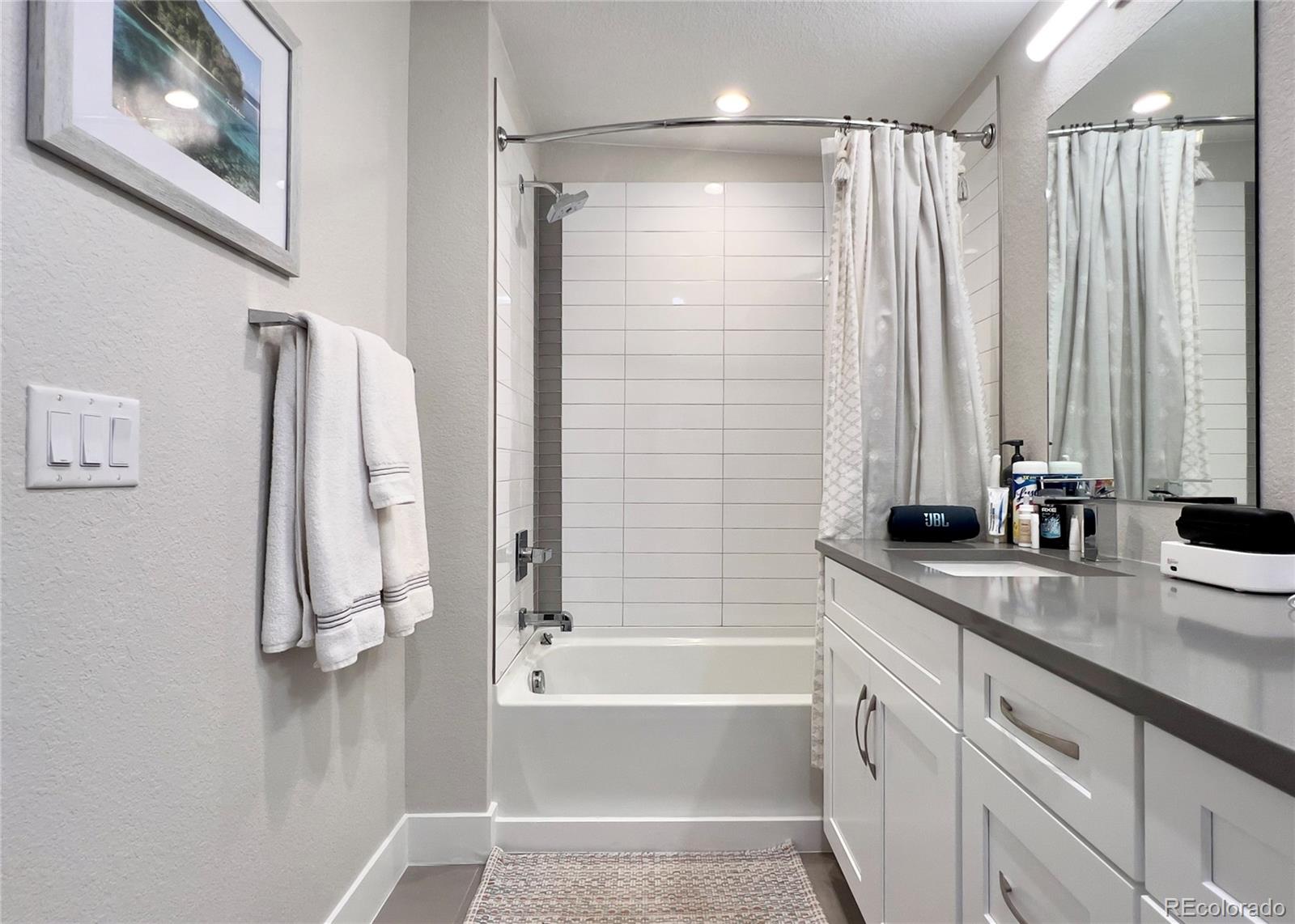 6228 West 38th Avenue Wheat Ridge, CO 80033 - Photo 21 of 38 a bathroom with a tub a sink and a shower
