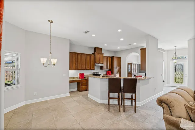 a kitchen with a refrigerator and furniture