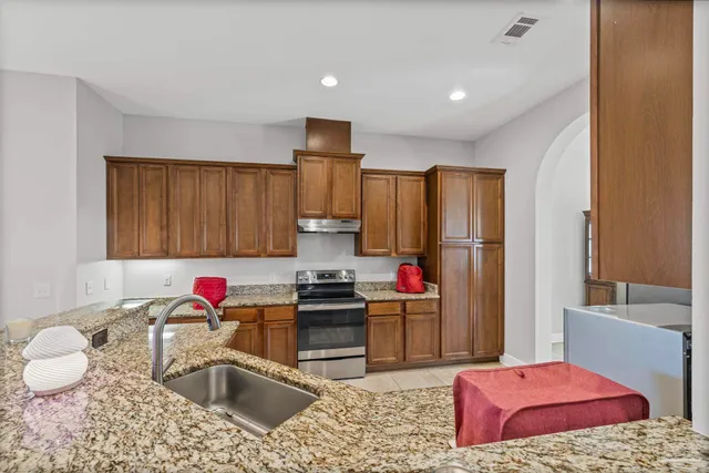 a kitchen with a sink stove and refrigerator