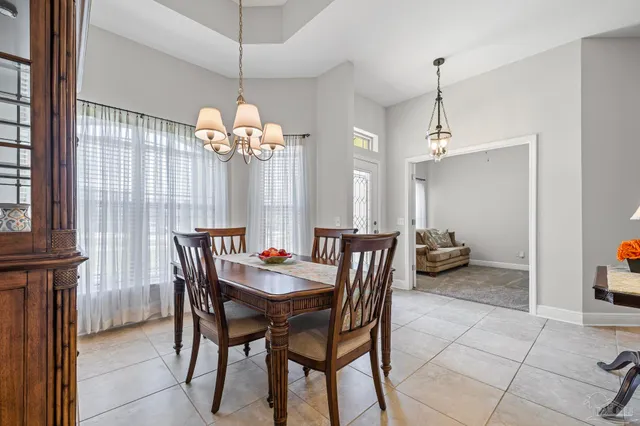 a dining room with furniture and window