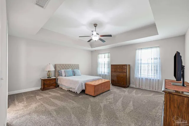 a bedroom with a bed and a television